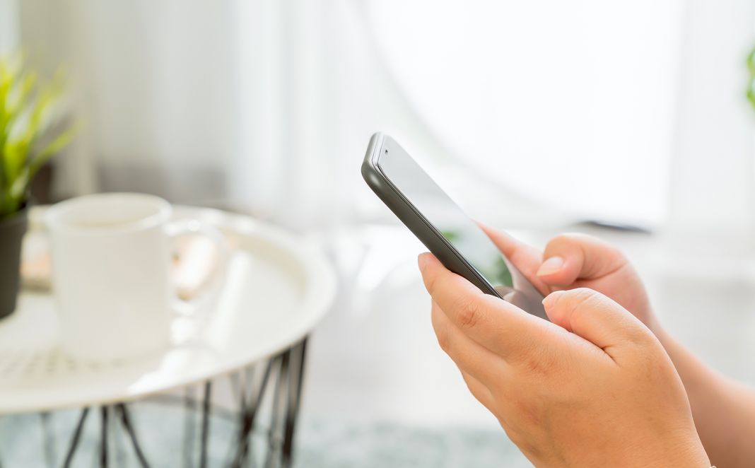 Hand Using Smartphone, During Leisure Time. The Concept Of Using The Phone Is Essential In Everyday Life.